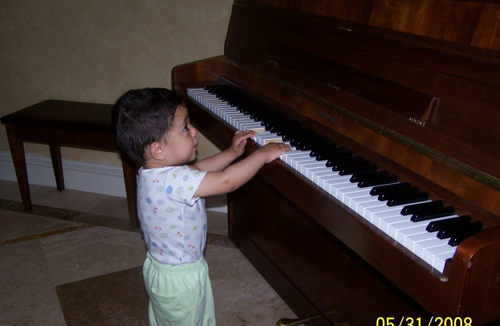 A young Ali Rad playing the piano for the first time
